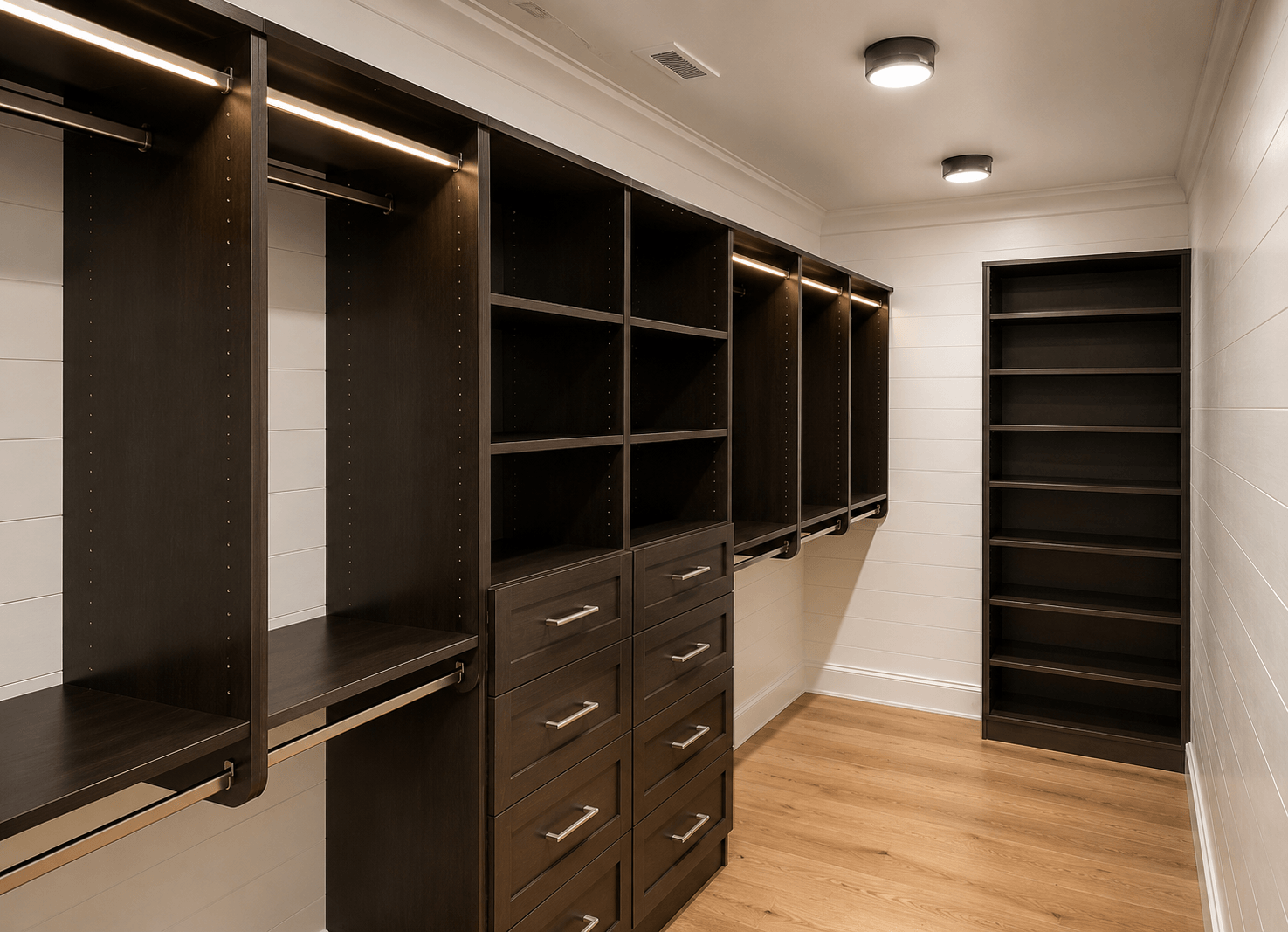 Custom walk-in closet with built-in shelving, hanging rods, and drawer storage.