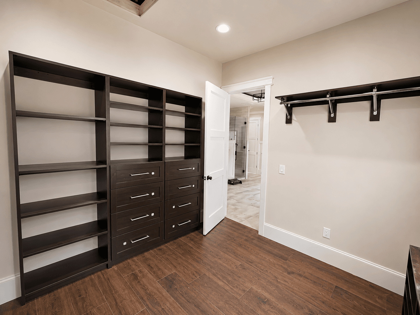 Walk-in closet organization system with built-in shelving and storage.