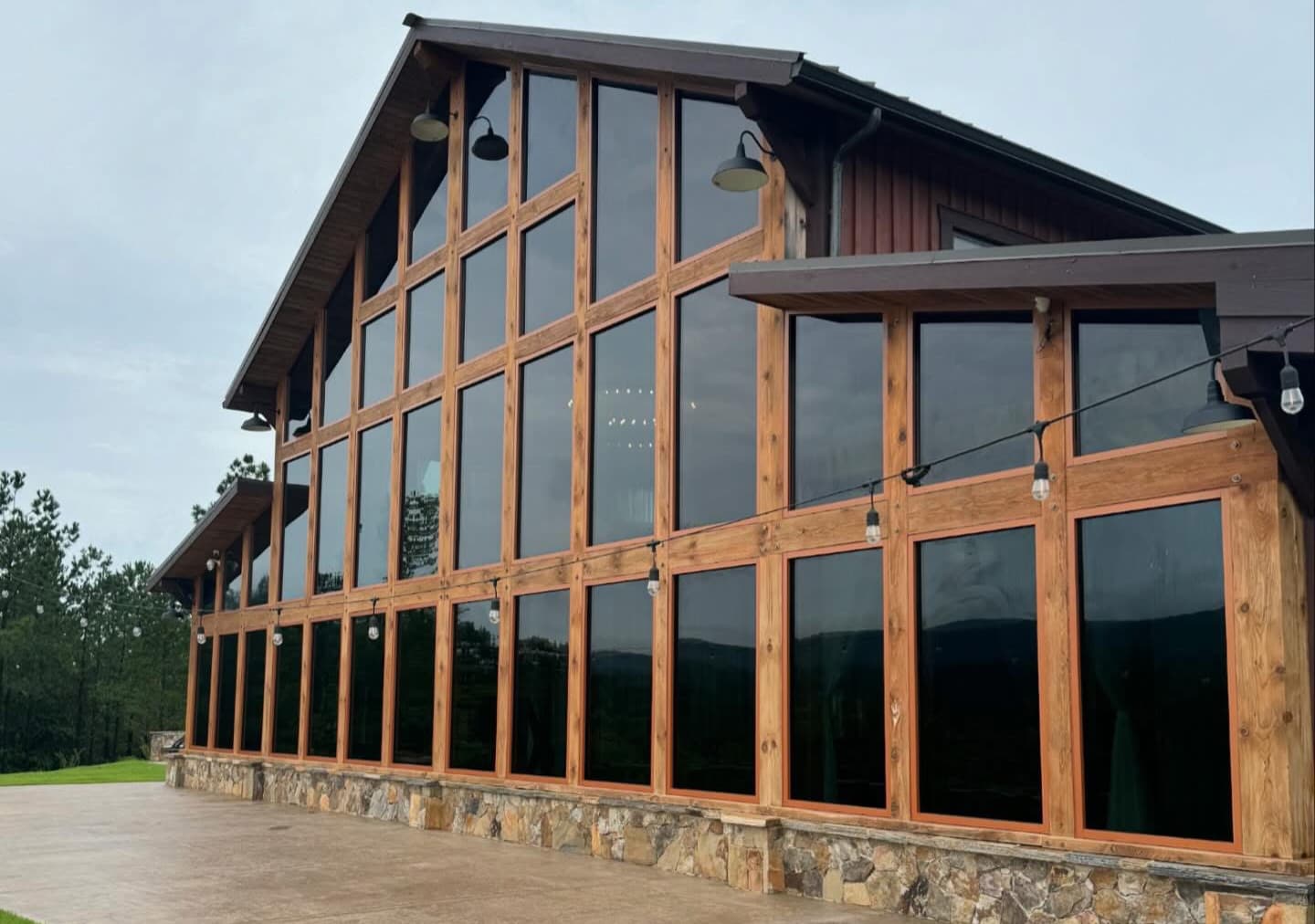 Commercial building exterior with glass curtain wall and landscaping.