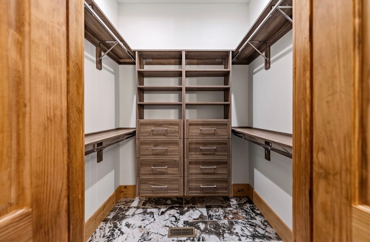 Custom closet design with built-in shelving and organized storage.