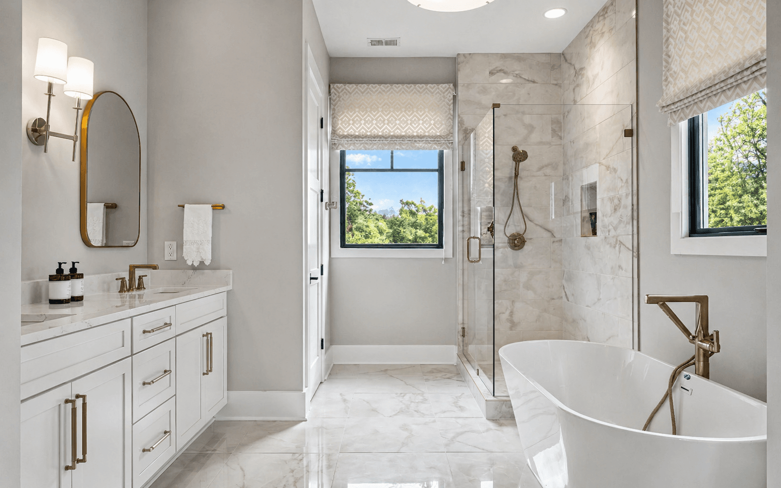 Custom frameless glass shower enclosure with tile walls and polished hardware.