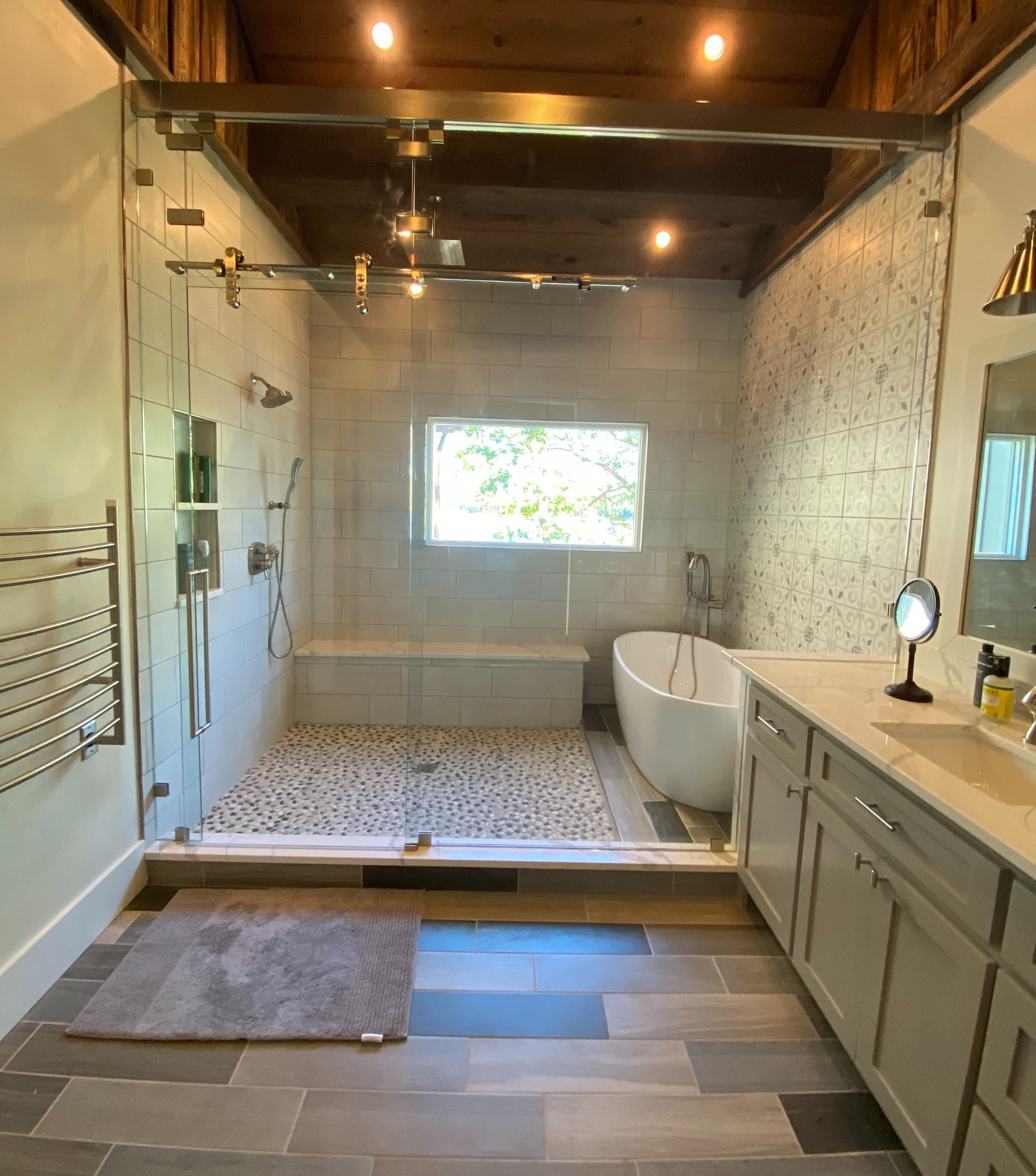 Large custom shower glass panels in a tiled bath.