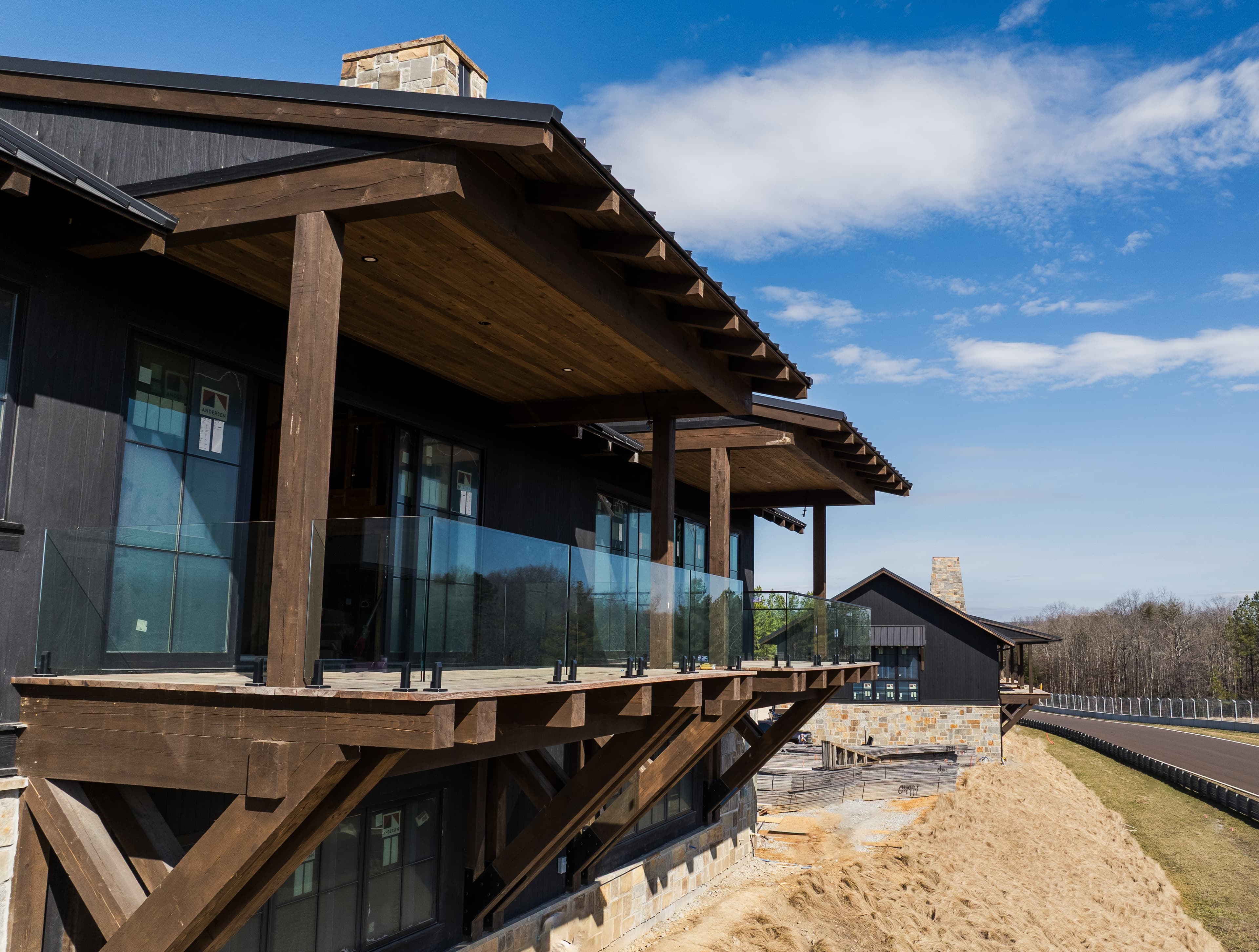 Glass railing detail—clear infill panels, posts, and hardware on a residential guard opening.