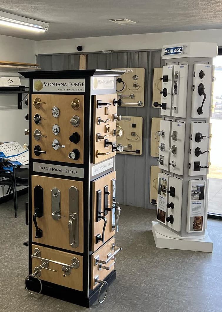 Showroom hardware displays—door levers, knobs, handlesets, and bath accessories on sample boards.
