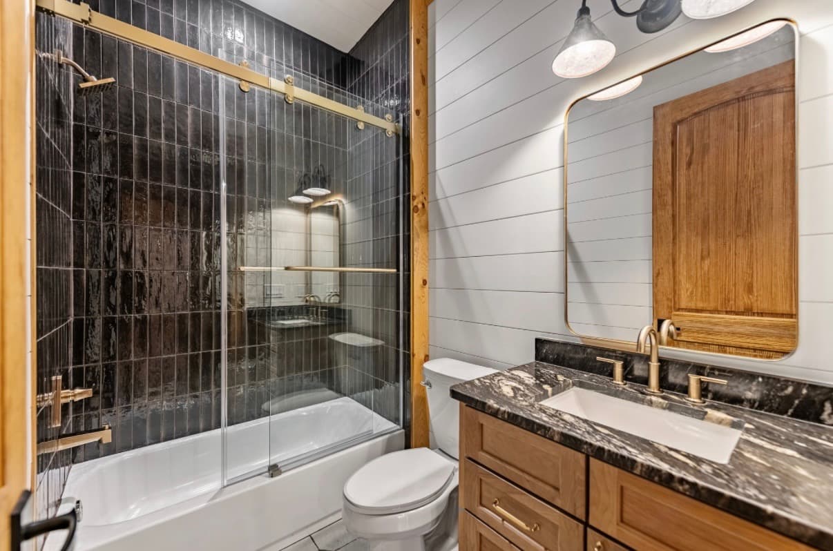 Sliding glass shower doors installed on a residential shower opening.