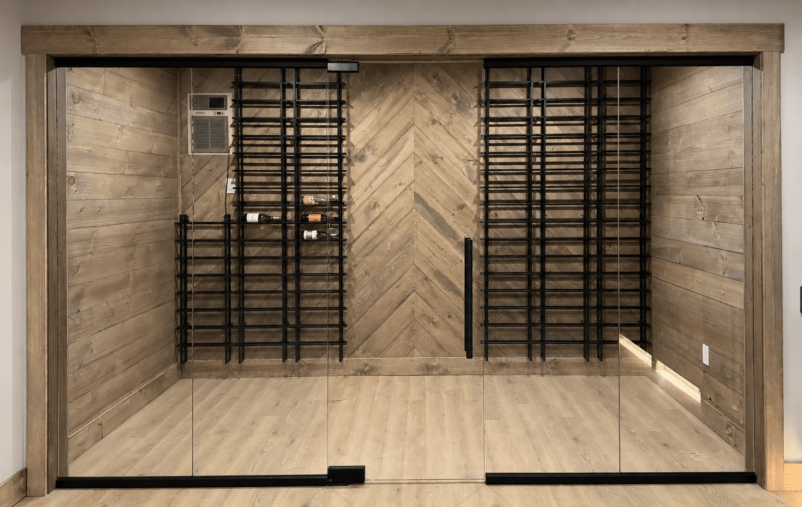 Glass-front wine cabinet wall with built-in display and lighting—residential finish and hardware coordination context.