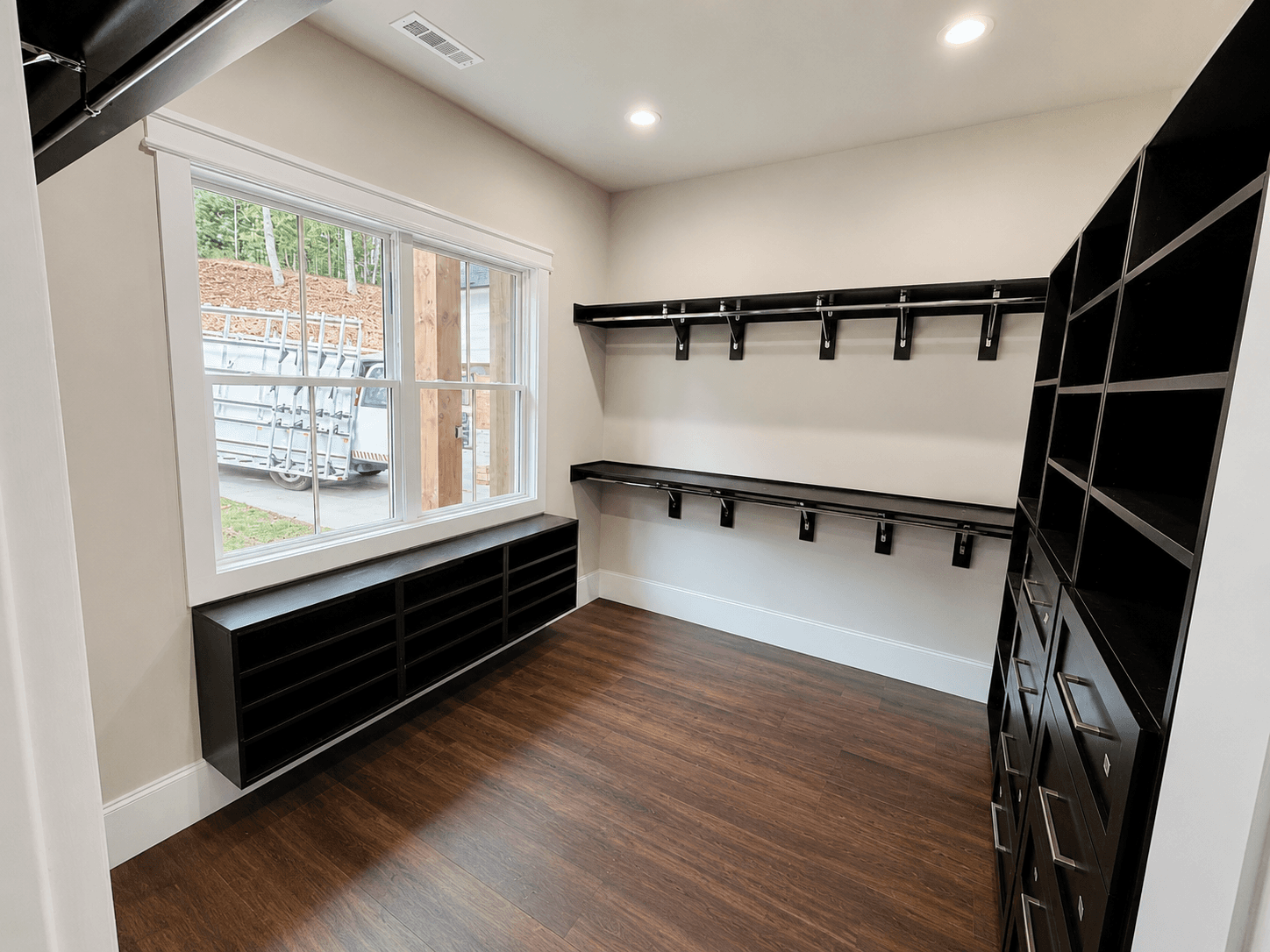 Walk-in closet organization system with shelving and hanging storage.