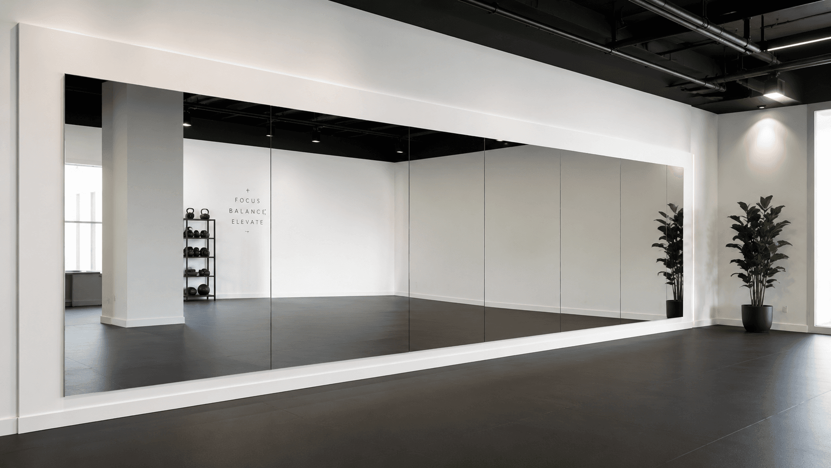 Large wall mirror installation in a home gym or studio space.