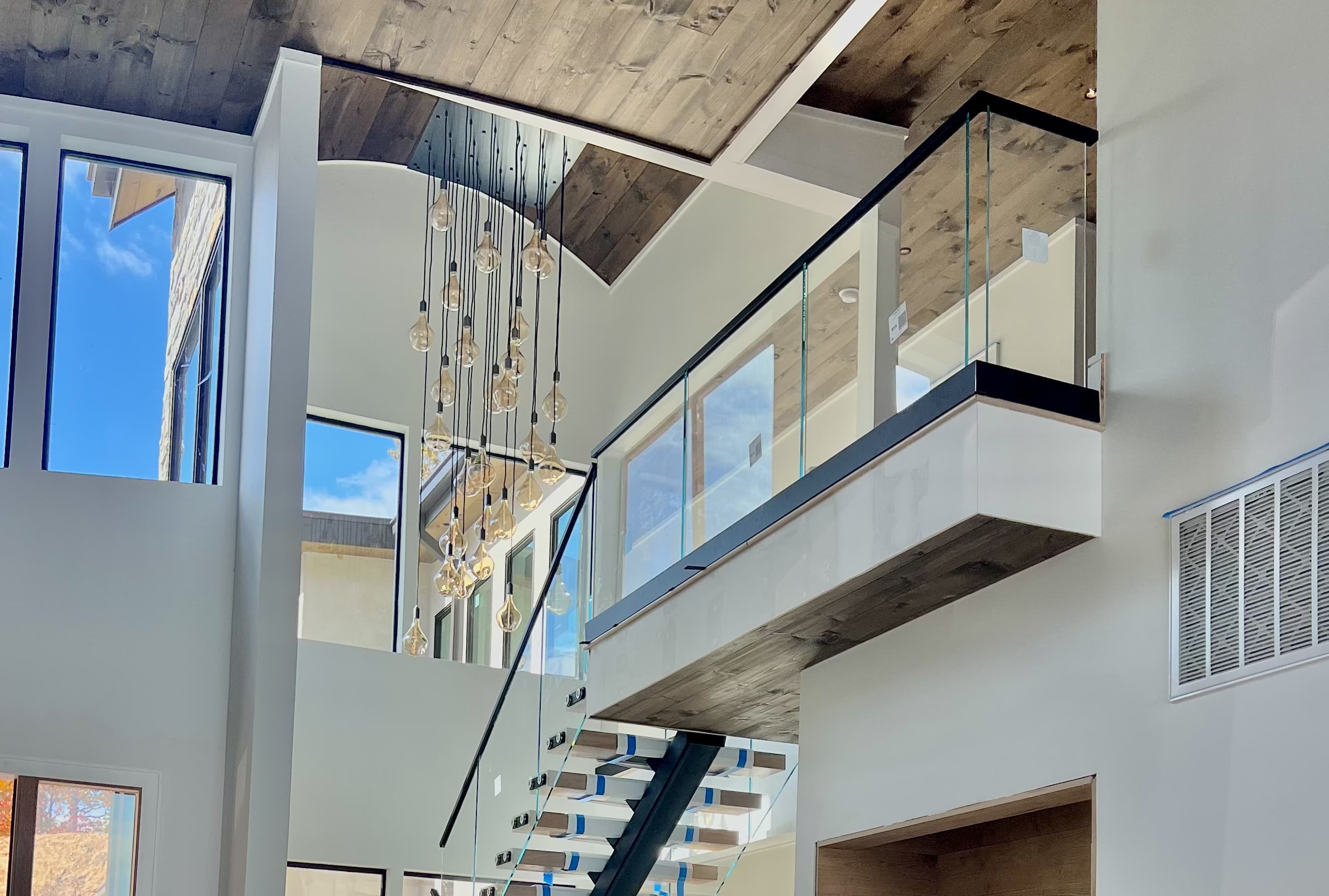 Interior glass railing panels and hardware on a stair or loft guard.