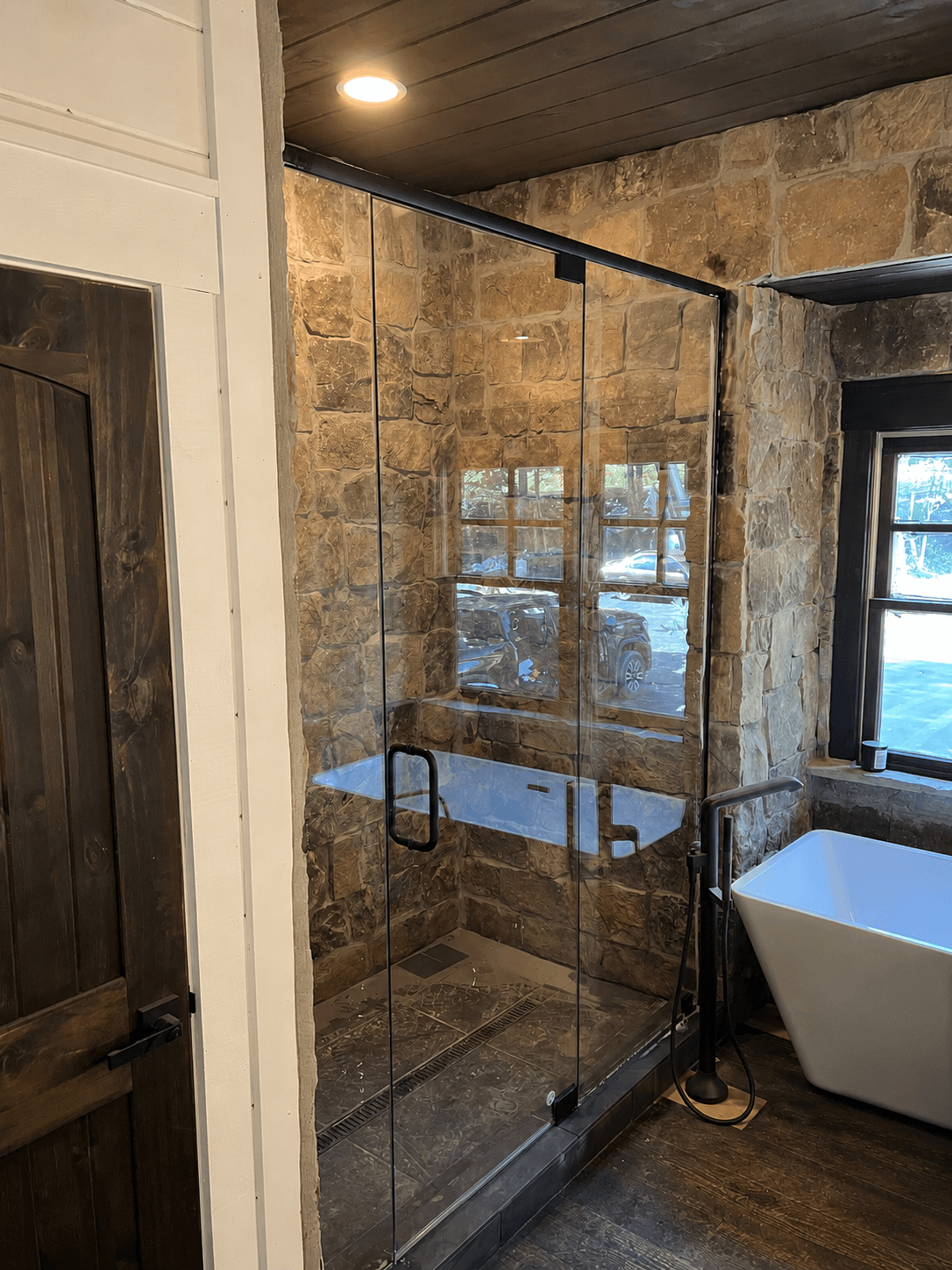 Frameless glass shower enclosure in a residential bathroom.
