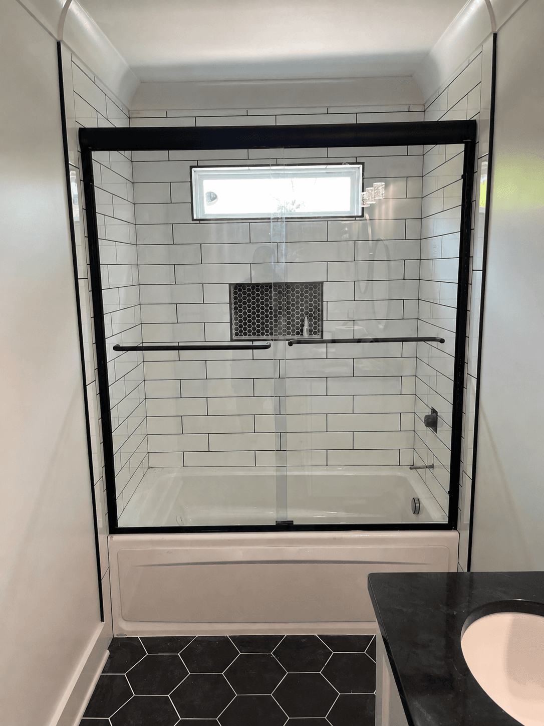 Sliding glass shower doors in a residential bathroom.