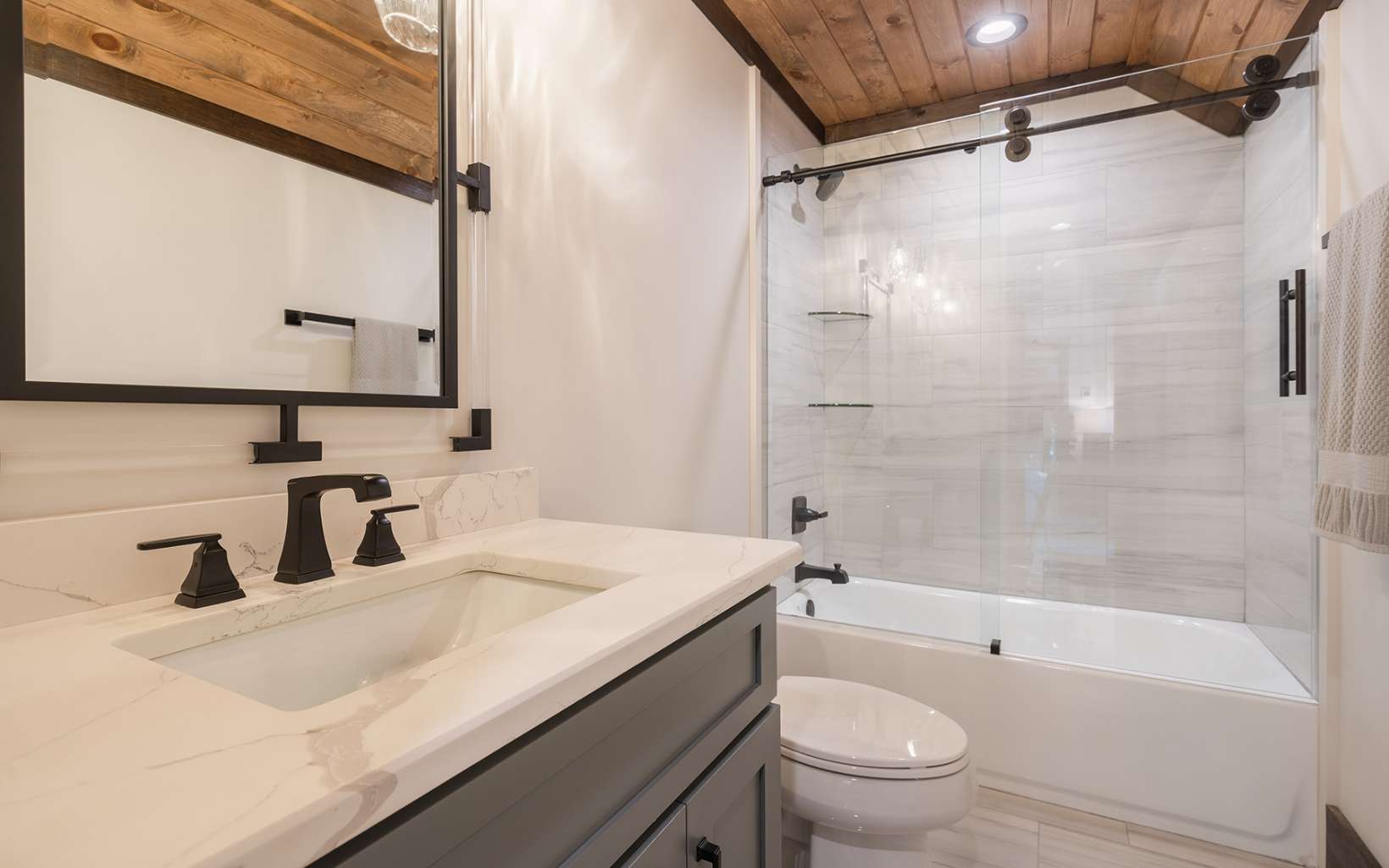 Sliding glass shower doors on a residential shower enclosure.