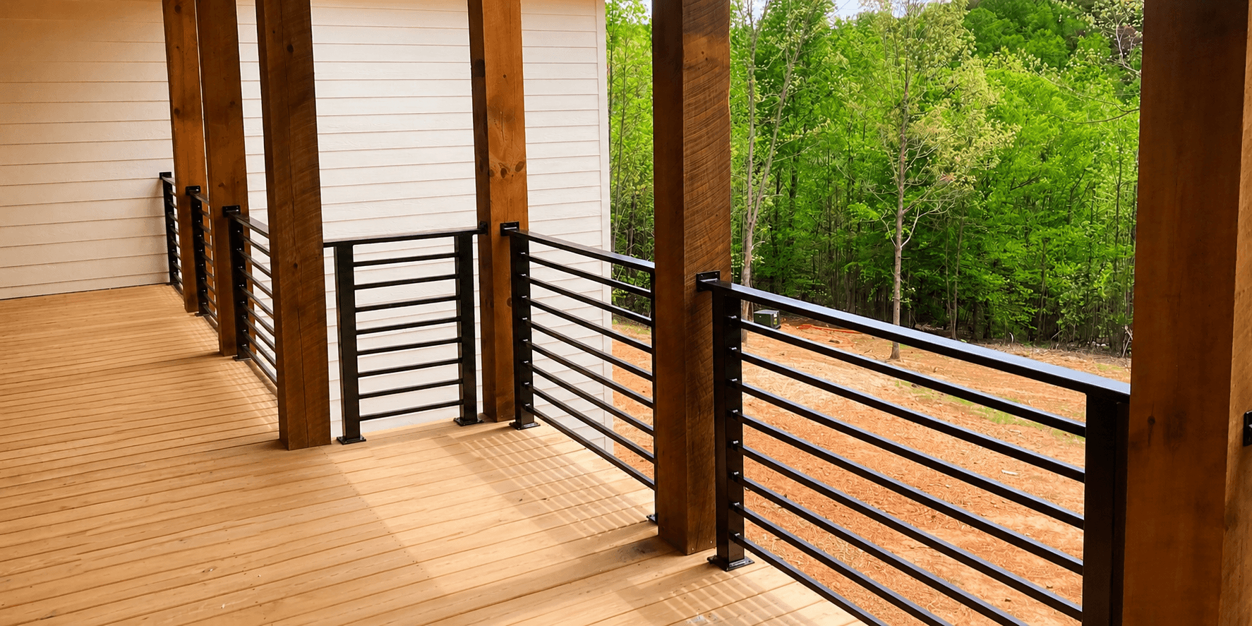 Wrought iron railing installation on a residential stair or deck opening.