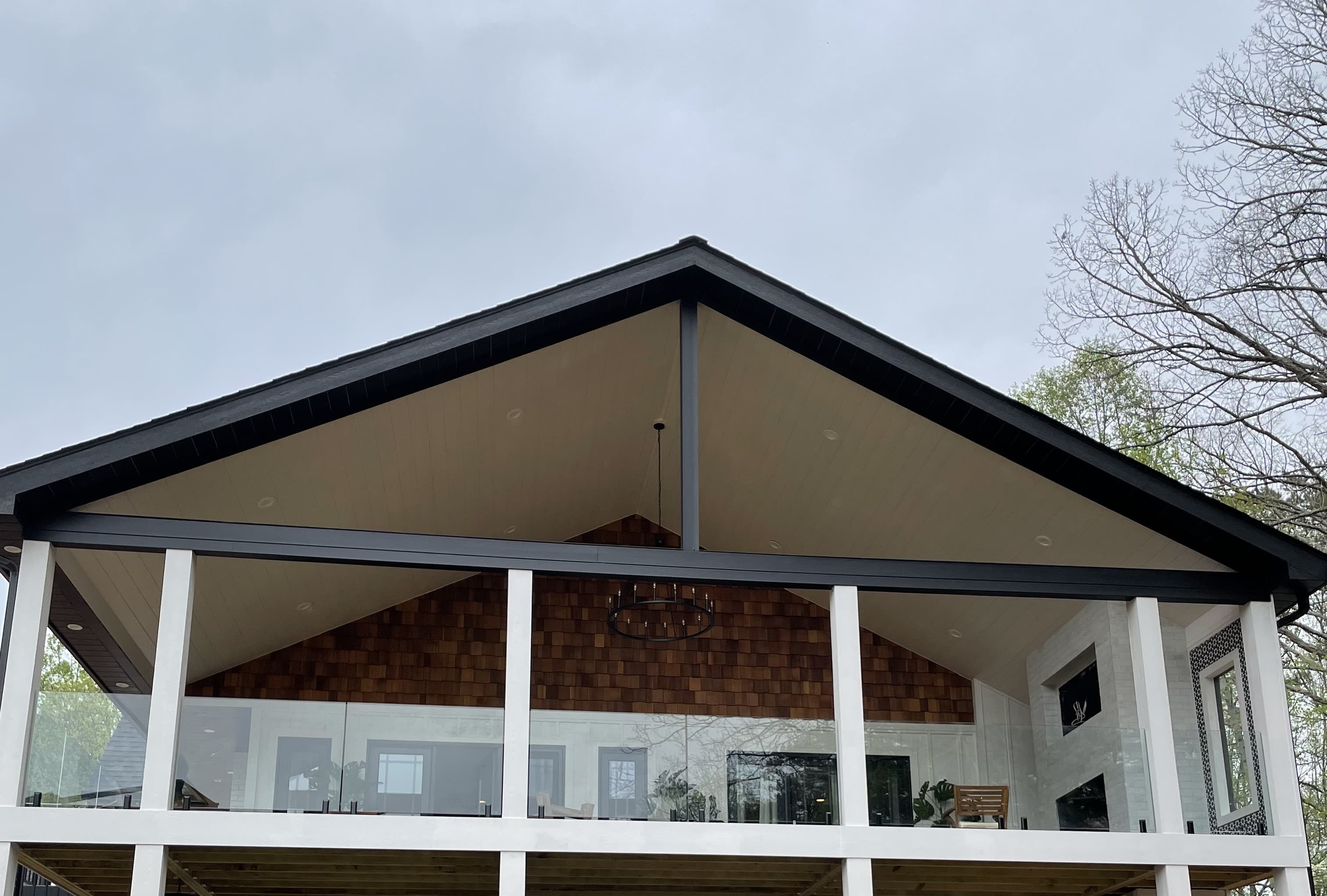Glass railing installation on site—panels, posts, and field fit-up along a residential opening.